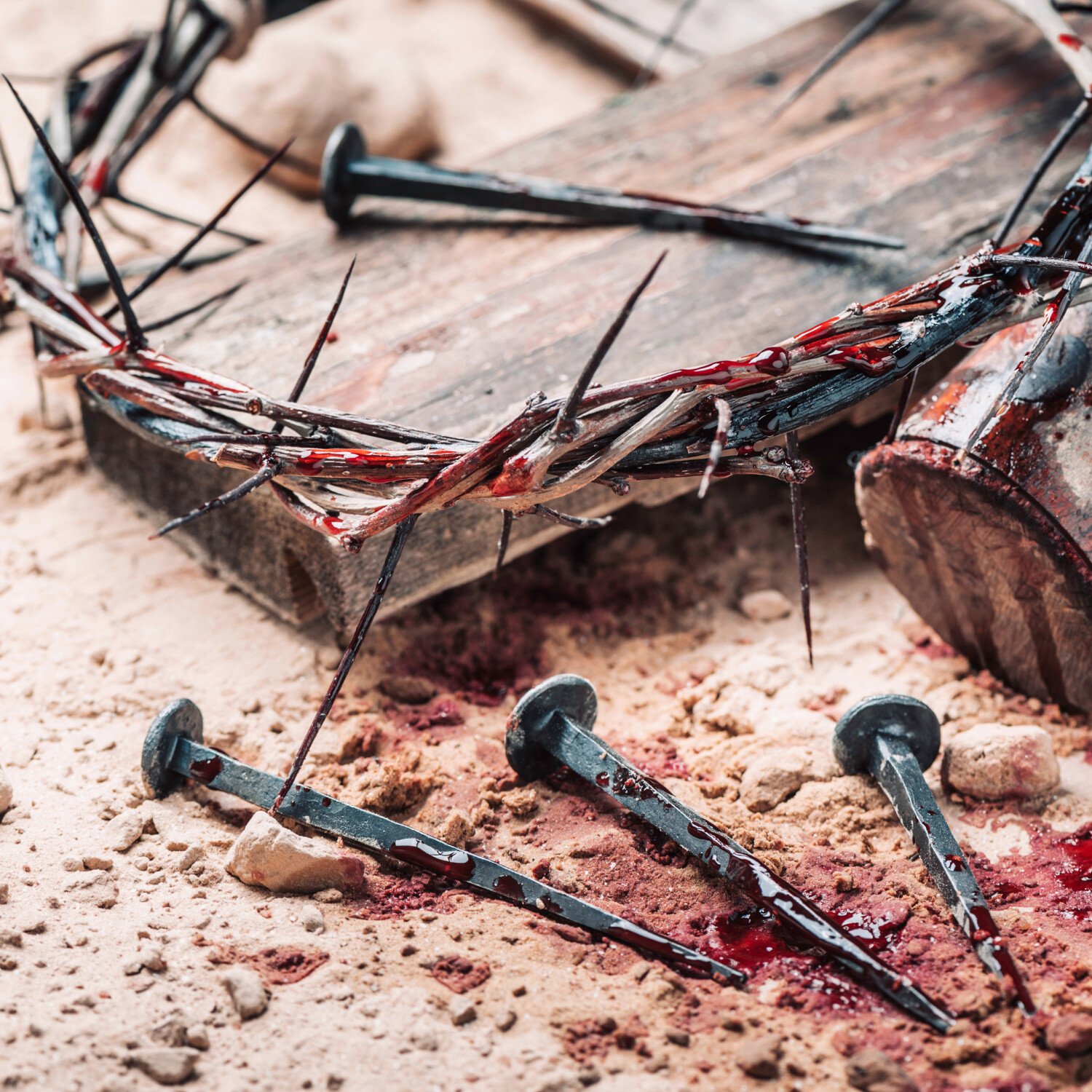 Old wooden cross, hammer, bloody nails and crown of thorns on ground. Banner. Copy space. Good friday. Passion, crucifixion of Jesus Christ. Christian Easter holiday. Gospel, salvation.
