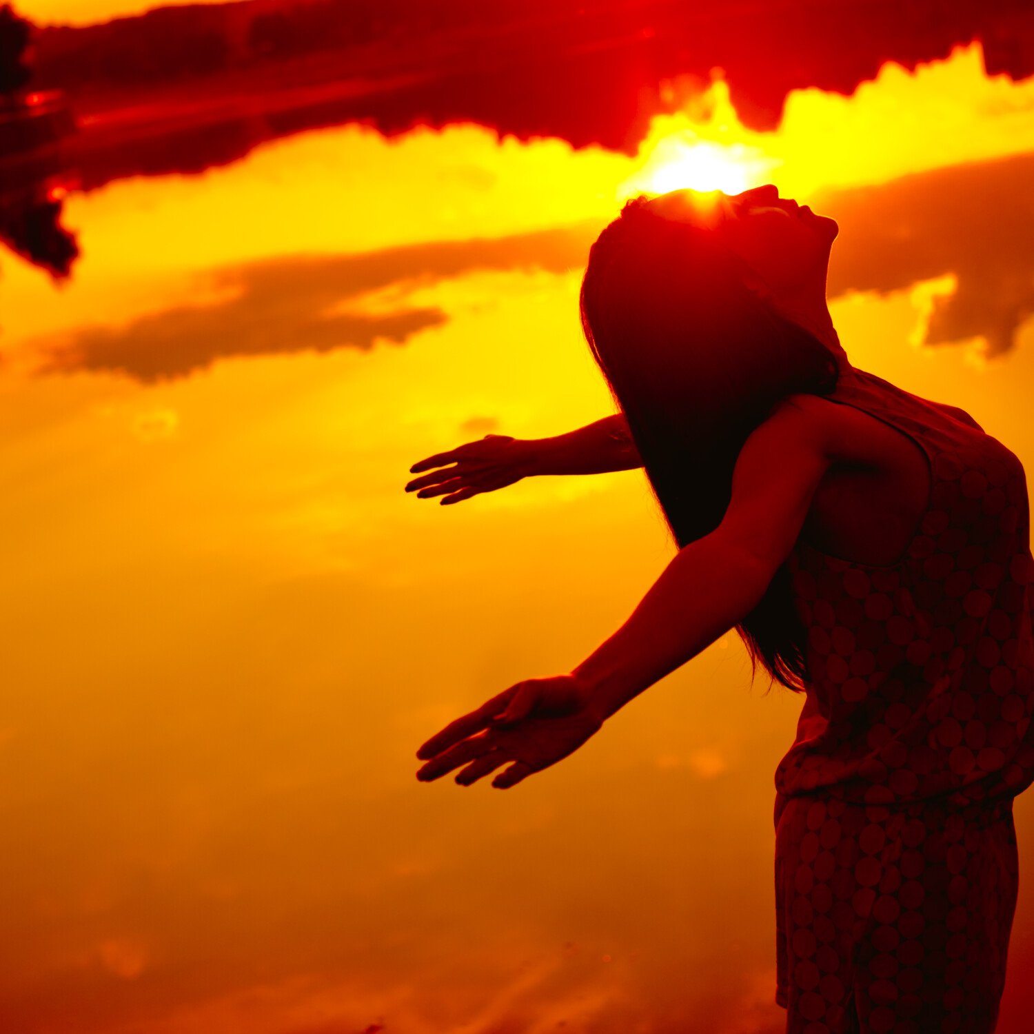 Young beautiful girl at sunset